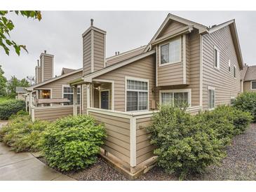 Charming exterior view of townhome featuring a wood facade and chimney, surrounded by lush landscaping at 6839 Zenobia St # 3, Westminster, CO 80030