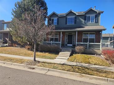 Charming two-story home with a welcoming front porch and well-maintained landscaping at 12453 Knox Ct, Broomfield, CO 80020