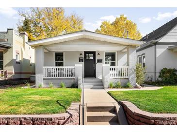 Charming home featuring a well-manicured front yard, covered porch, and classic architectural details at 3884 Osceola St, Denver, CO 80212