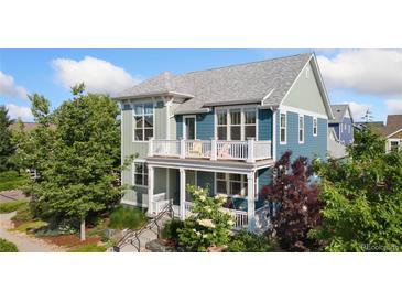 Charming two-story home featuring dual-tone exterior paint, a second-story balcony, and a welcoming front porch at 2856 Shadow Lake Rd, Lafayette, CO 80026