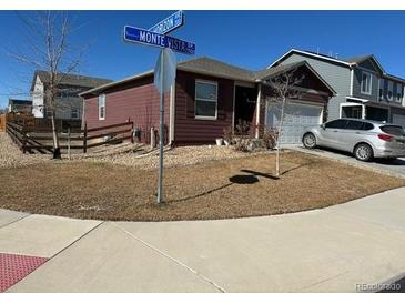 Well-maintained single-Gathering home with manicured lawn and attached two-car garage at 2003 Monte Vista Dr, Lochbuie, CO 80603