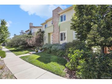 Charming multi-story home featuring manicured lawn and stone accents at 3379 Cranston Cir, Littleton, CO 80126