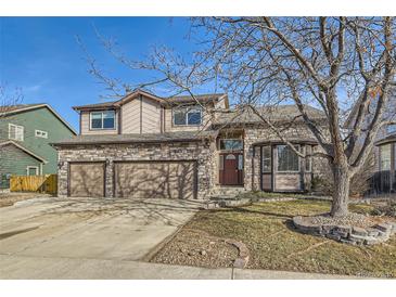 Charming two-story home featuring a stone facade and a well-manicured lawn on a sunny day at 270 Terra Vista St, Brighton, CO 80601