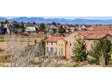 Beautiful exterior view of a home in a neighborhood with a mountain view at 9581 Firenze Way, Highlands Ranch, CO 80126