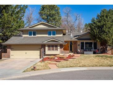 Charming two-story home with attached two-car garage and well-manicured front lawn and mature trees at 4967 E Lake Ave, Centennial, CO 80121