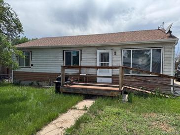 Modest single-story home featuring a small front porch and a weathered facade, in need of some TLC at 1105 S Raleigh St, Denver, CO 80219