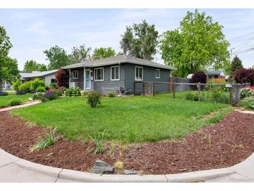 Charming gray home featuring a well-maintained lawn and beautiful landscaping at 6223 Gray St, Arvada, CO 80003