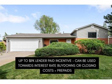 Charming single-story home with well-maintained lawn and attached two-car garage at 3322 Simms St, Wheat Ridge, CO 80033