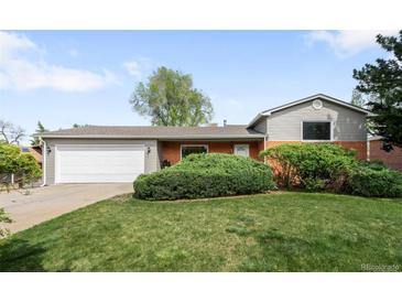 Charming single-Gathering home with a well-maintained lawn and attached two car garage at 3322 Simms St, Wheat Ridge, CO 80033