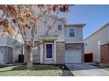 Charming two-story home with brick accents, a well-maintained lawn, and a delightful tree in the front yard at 3734 Dexter St, Denver, CO 80207