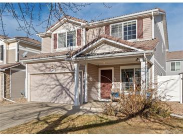 Two-story house with attached garage and landscaping at 19813 E 47Th Ave, Denver, CO 80249