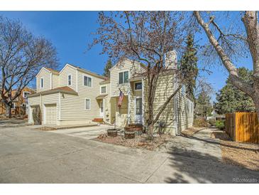 Charming two-story home featuring an attached garage and traditional siding at 12935 W 64Th Dr # D, Arvada, CO 80004