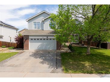 Charming two-story home showcasing a well-manicured front yard and a two car garage at 4715 E 127Th Dr, Thornton, CO 80241