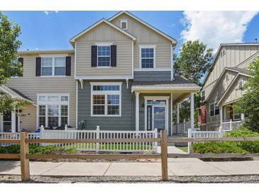 Charming two-story home with a well-maintained lawn and a white picket fence at 1484 Nemrick Pl, Castle Rock, CO 80109