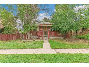 Charming brick home with a cozy front porch and a well-maintained lawn, creating a welcoming curb appeal at 1457 S Franklin St, Denver, CO 80210