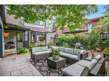 Inviting backyard patio with comfortable seating and mature trees for shade at 4570 Irving St, Denver, CO 80211