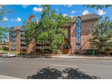 Charming brick condo building with Tudor-style elements and mature trees at 1350 Josephine St # 508, Denver, CO 80206