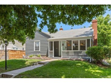 Charming home with grey siding, brick chimney, covered porch, and green lawn at 1738 S Franklin St, Denver, CO 80210