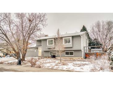 Charming gray home with a spacious front yard and attached two-car garage at 2152 Grant St, Longmont, CO 80501