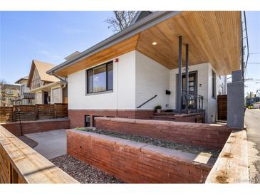Charming home featuring a modern exterior with brick accents and a well-maintained front yard at 1922 E 18Th Ave, Denver, CO 80206