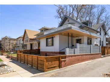 Inviting exterior elevation with wood and brick facade, showcasing modern architectural details at 1922 E 18Th Ave, Denver, CO 80206