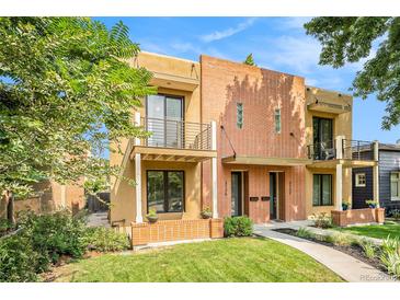 Charming exterior elevation showcasing a two-story home with brick accents, balconies, and a well-manicured lawn at 3126 Perry St, Denver, CO 80212