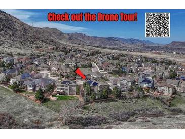 Expansive aerial view of a neighborhood nestled against the mountains, highlighting the community's natural setting at 580 Eagle Nest Ct, Golden, CO 80401
