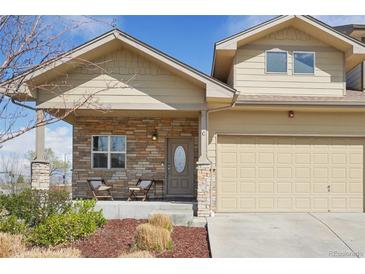 Charming home featuring stone accents, a covered porch, and a well-maintained front yard at 6760 Meade Cir # C, Westminster, CO 80030