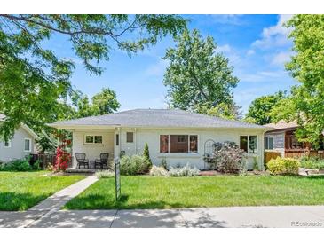 Charming home with a well-manicured lawn, sidewalk and beautiful landscaping in front at 3177 S Grant St, Englewood, CO 80113
