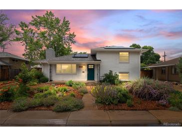 Charming white brick home with landscaped front yard and colorful dusk sky, adding to its curb appeal at 5315 Newland St, Arvada, CO 80002