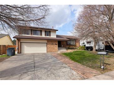 Charming two-story home featuring a brick facade, attached garage and a well-maintained front yard at 530 S Laredo Cir, Aurora, CO 80017