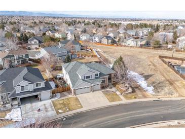 An aerial view of a two-story home with an attached two-car garage in a suburban neighborhood at 18981 E Belleview Pl, Centennial, CO 80015