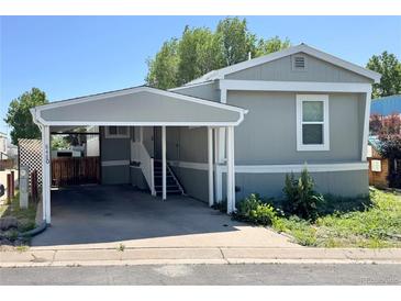 Charming home featuring a convenient carport and well-maintained yard at 8480 Adams Way, Denver, CO 80229