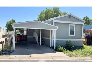Charming single-story home with a covered parking area and well-maintained landscaping at 8480 Adams Way, Denver, CO 80229