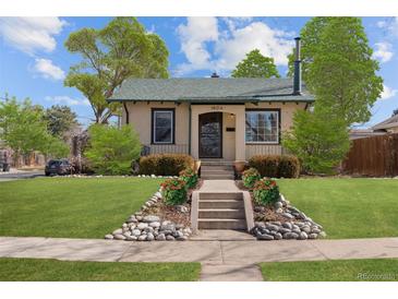 Charming home featuring a well-manicured lawn, inviting front steps, and lovely landscaping at 1804 S Corona St, Denver, CO 80210