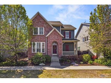 Charming two-story home with brick accents and a cozy front porch at 3529 Xanthia Ct, Denver, CO 80238