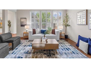 Bright living room with natural light, modern furniture, and stylish decor at 3529 Xanthia Ct, Denver, CO 80238