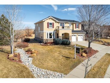 Charming two-story home with a well-manicured lawn, appealing stone accents, and a convenient two-car garage at 4939 Silver Feather Cir, Broomfield, CO 80023