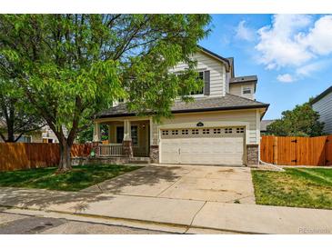 Charming two-story home featuring a well-maintained front yard and an attached two-car garage at 1248 Button Rock Dr, Longmont, CO 80504