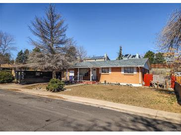 Charming one-story brick home with a well-maintained front yard and mature trees at 4291 W Wagon Trail Dr, Littleton, CO 80123