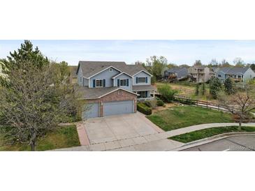 Charming two-story home with a three-car garage and well-maintained landscaping at 650 Olympia Ave, Longmont, CO 80504
