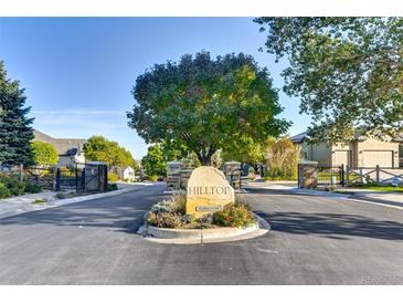 Community entrance with a boulder sign, landscaping, and gated entries to the Hilltop neighborhood at 11017 Meade Ct, Westminster, CO 80031