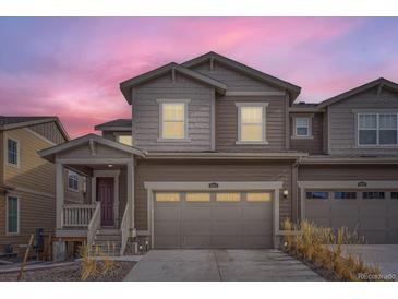 Charming two-story home boasts a two-car garage and welcoming front porch with fresh, neutral paint at 9012 Borrowdale Ln, Parker, CO 80134
