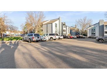 Exterior view of the building with parking lot at 14046 E Stanford Cir # I04, Aurora, CO 80015