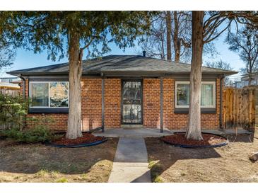 Charming red brick home with mature trees and a well-manicured lawn at 832 Dahlia St, Denver, CO 80220