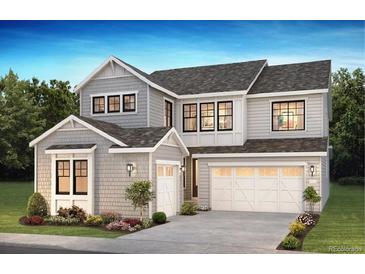 Two-story home with gray siding, white trim, and a three-car garage at 8844 Moonshimmer Trl, Littleton, CO 80125