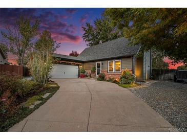 Charming home with a two-car garage and beautiful landscaped front yard and front porch at 8691 Bluebunch Ct, Parker, CO 80134