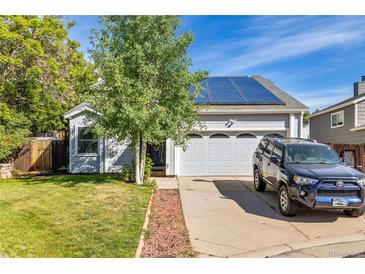 Inviting home exterior featuring solar panels, a well-kept lawn, and an attached two-car garage at 9805 Garrison Ct, Broomfield, CO 80021