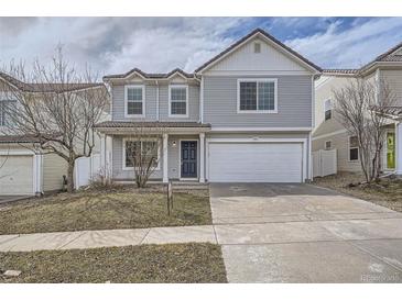 Charming two-story home featuring gray siding, a two-car garage, and a well-maintained front yard at 5547 Himalaya Rd, Denver, CO 80249