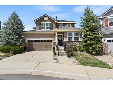 Charming two-story home with a well-manicured lawn and a welcoming entrance, showcasing curb appeal at 11007 Meadowvale Cir, Highlands Ranch, CO 80130